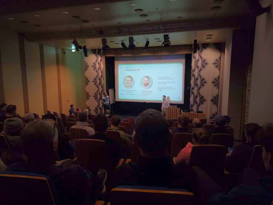 Tidsbanken holder kick-off opplæring for en sal med ansatte hos Byggmester Hitland. Det er et bilde med en powerpoint